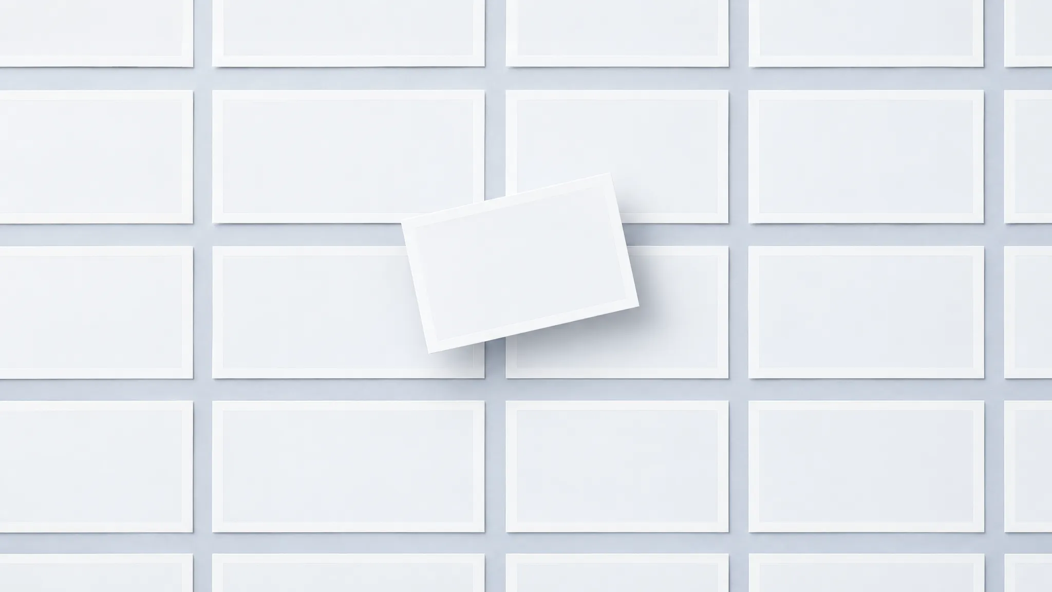 A single unlabeled photograph floating anonymously among a crowd of identical blank frames